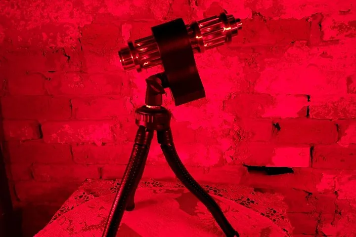 Ghost hunting equipment on a tripod under red lighting
